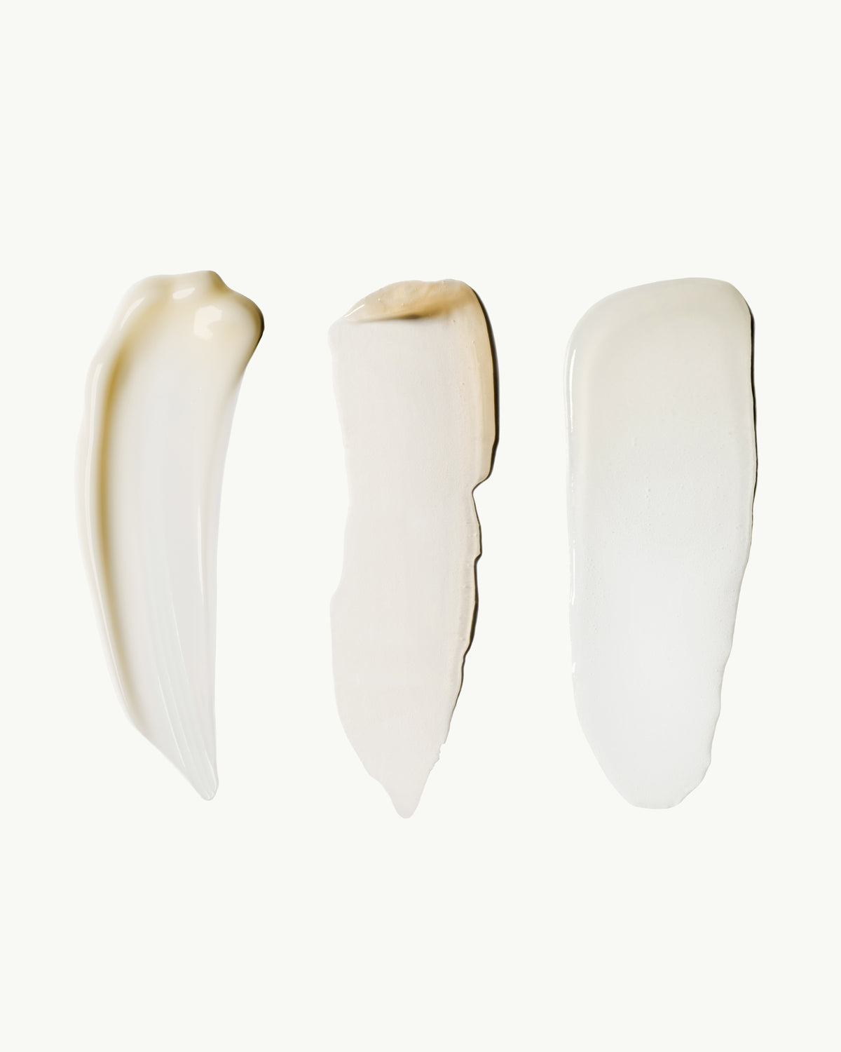 Wrinkle Pen, Lip Serum, and Facial Serum cream swatches showcasing the Essential Collection formulas