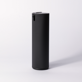 The black ribbed Facial Serum pump bottle standing alone on a soft white studio background.