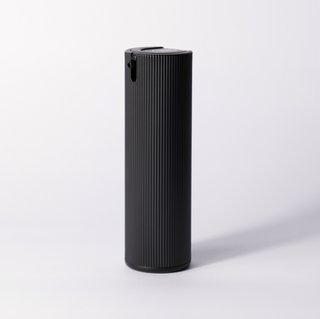 The black ribbed Facial Serum pump bottle standing alone on a soft white studio background.