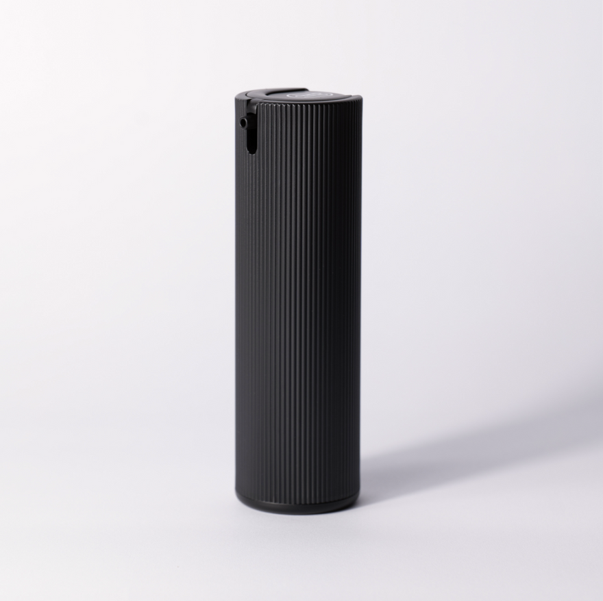 The black ribbed Facial Serum pump bottle standing alone on a soft white studio background.