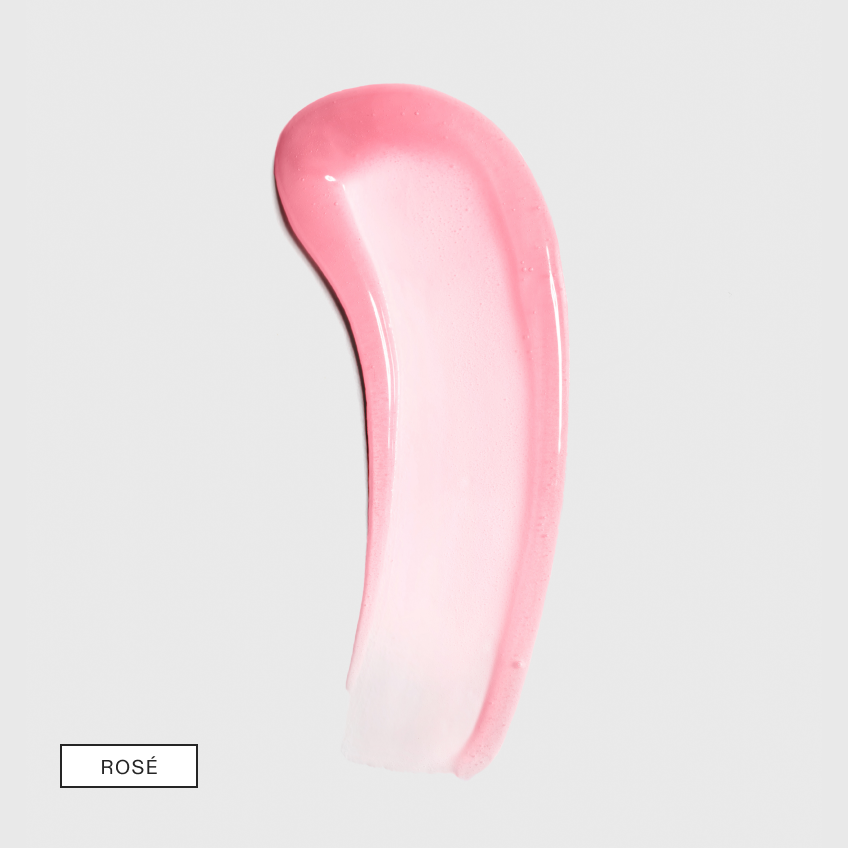 A curved smear of pink-tinted serum fading to sheer on light grey with a boxed shade label in the lower left