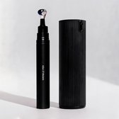 Packshot of the duo on a plain grey background: the black Wrinkle Pen with its metal applicator tip uncapped, standing beside the tall ribbed black Facial Serum bottle