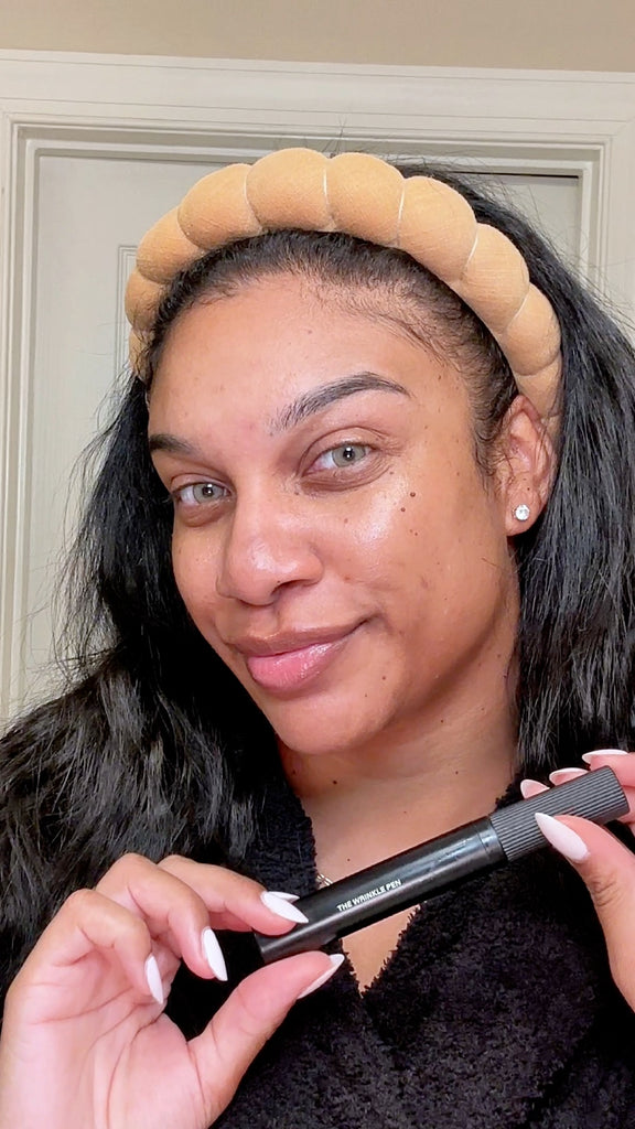 Adriana smiling and holding the Wrinkle Pen